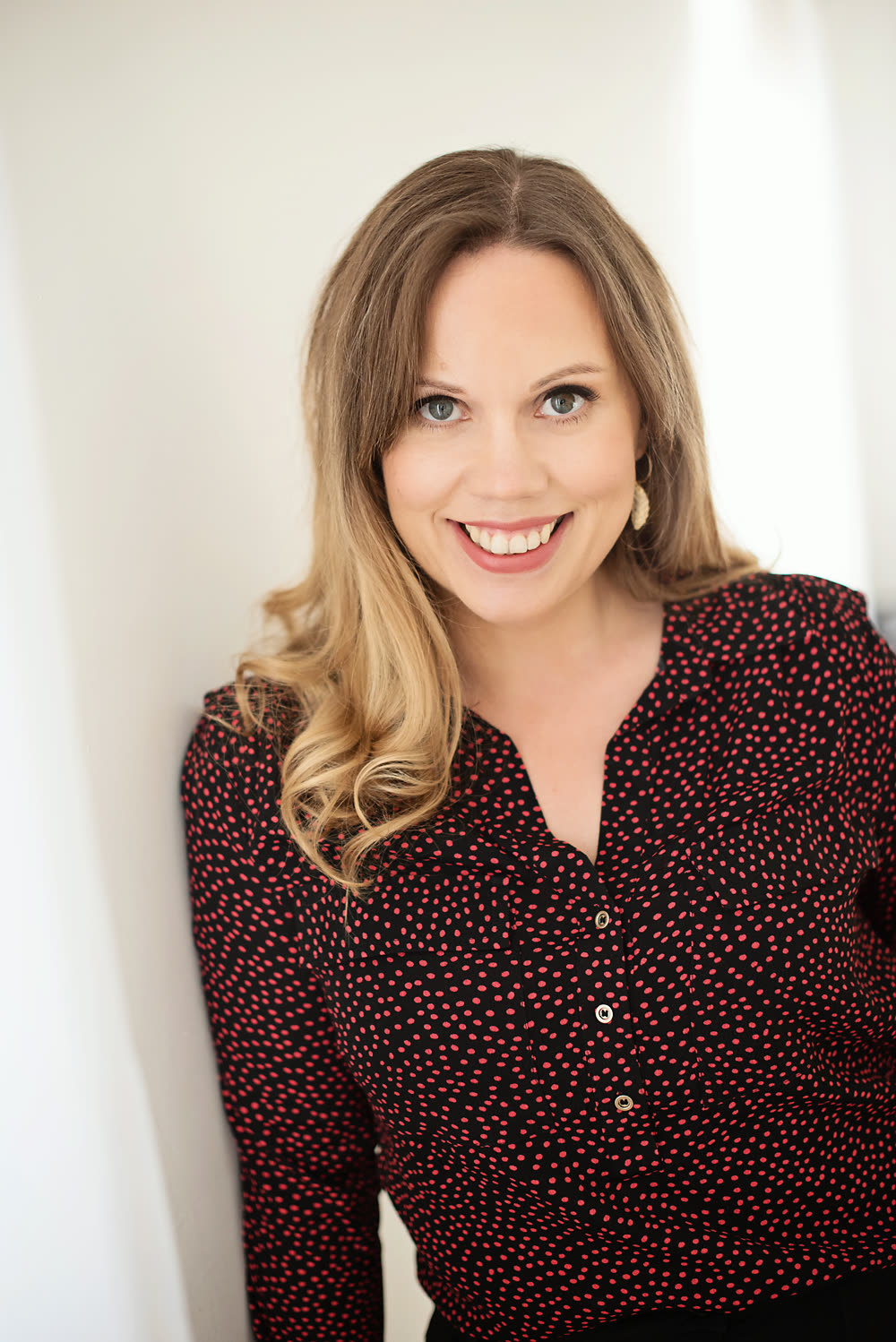 Portrait of Joanne Whitehead in a black blouse with red polka dots